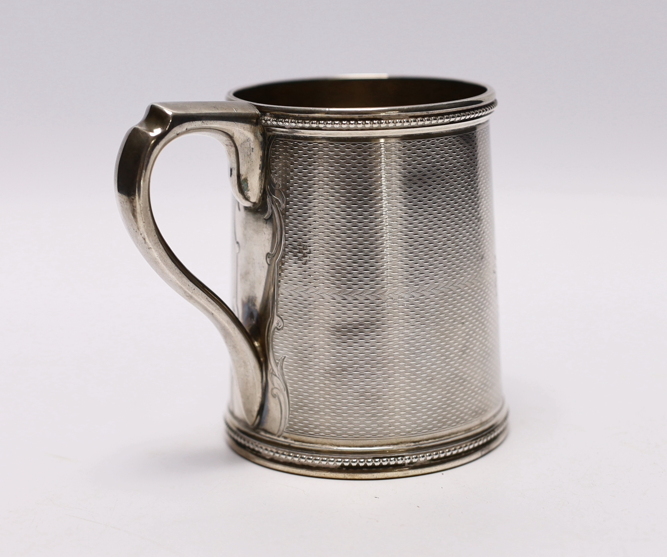 A mid 19th century Tiffany & Co (Grosjean & Woodward) engine turned sterling mug, with engraved inscription, 97mm, 6.9oz.